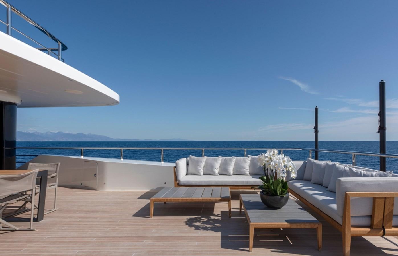 a patio with a table and chairs aboard MYKO Yacht for Sale