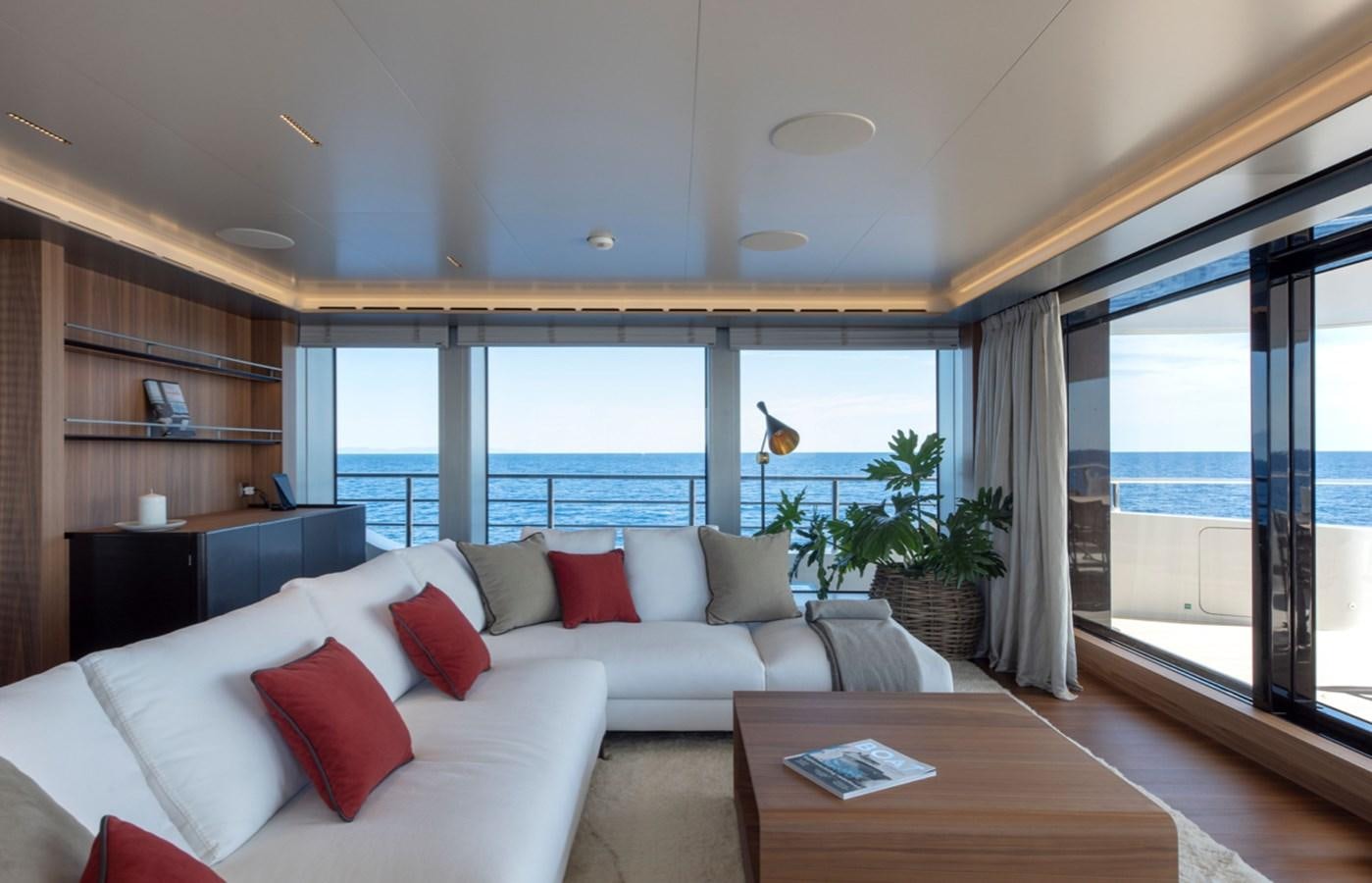 a living room with a large window aboard MYKO Yacht for Sale