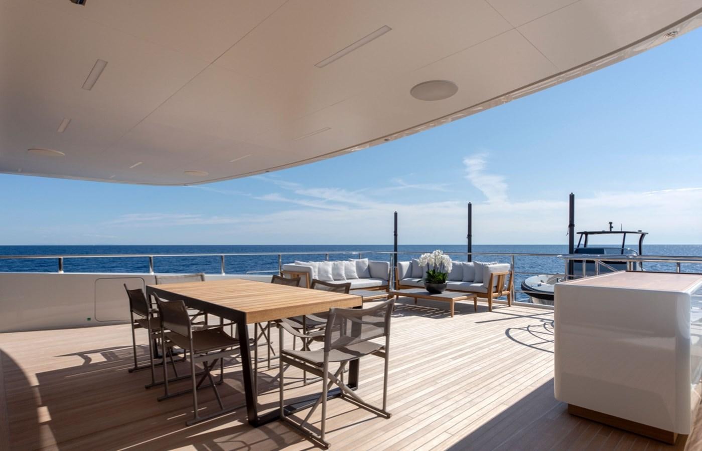 a room with a table and chairs aboard MYKO Yacht for Sale