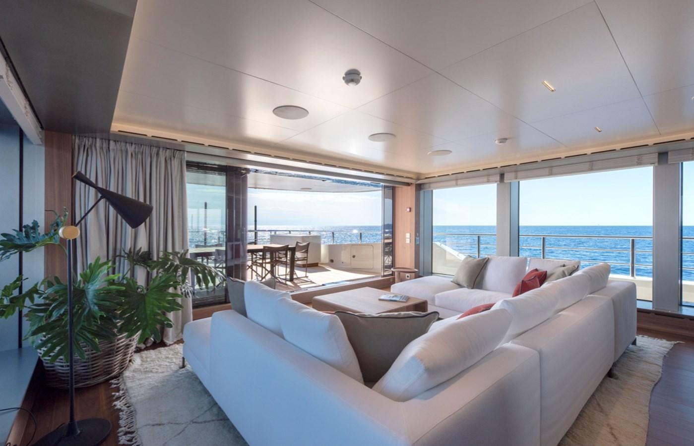 a living room with a large window aboard MYKO Yacht for Sale