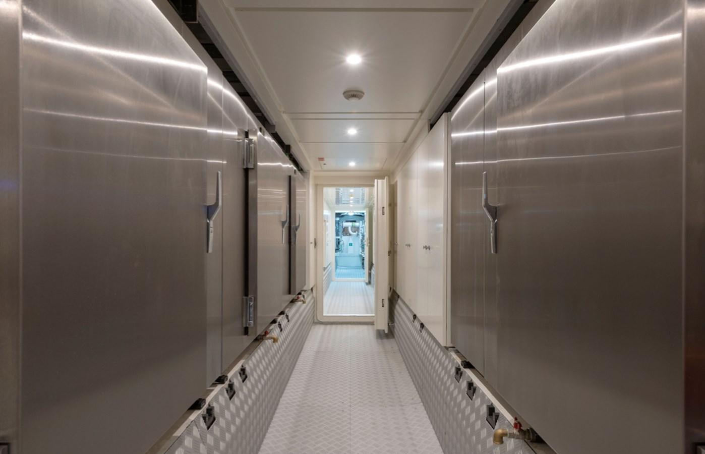 a hallway with a door and a machine on the floor aboard MYKO Yacht for Sale