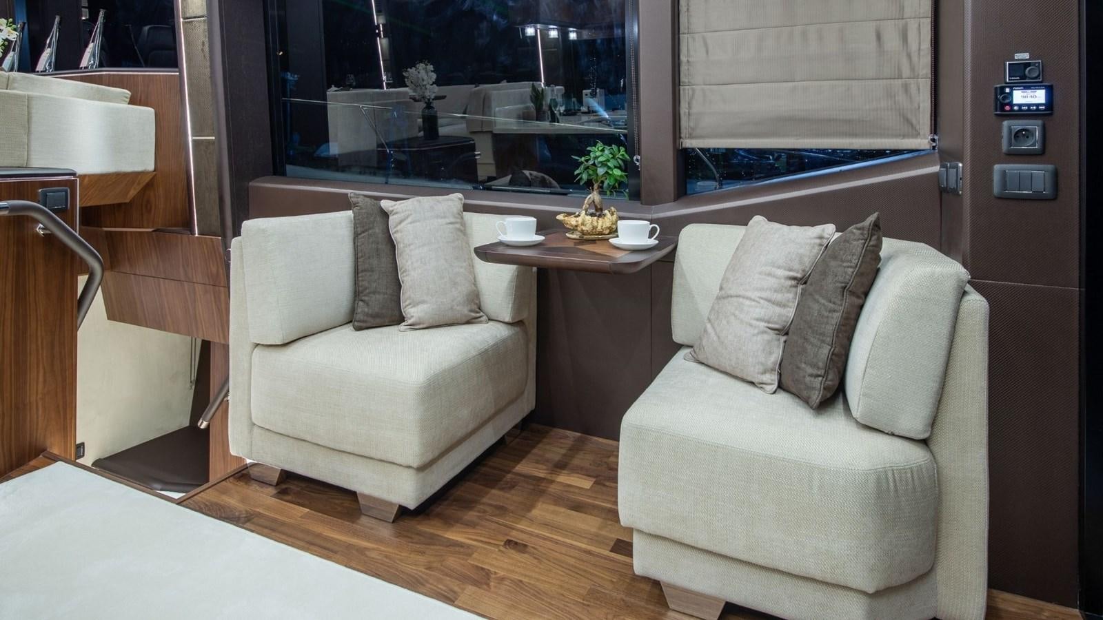 a room with a couch and a table aboard GALEON 680 FLY Yacht for Sale