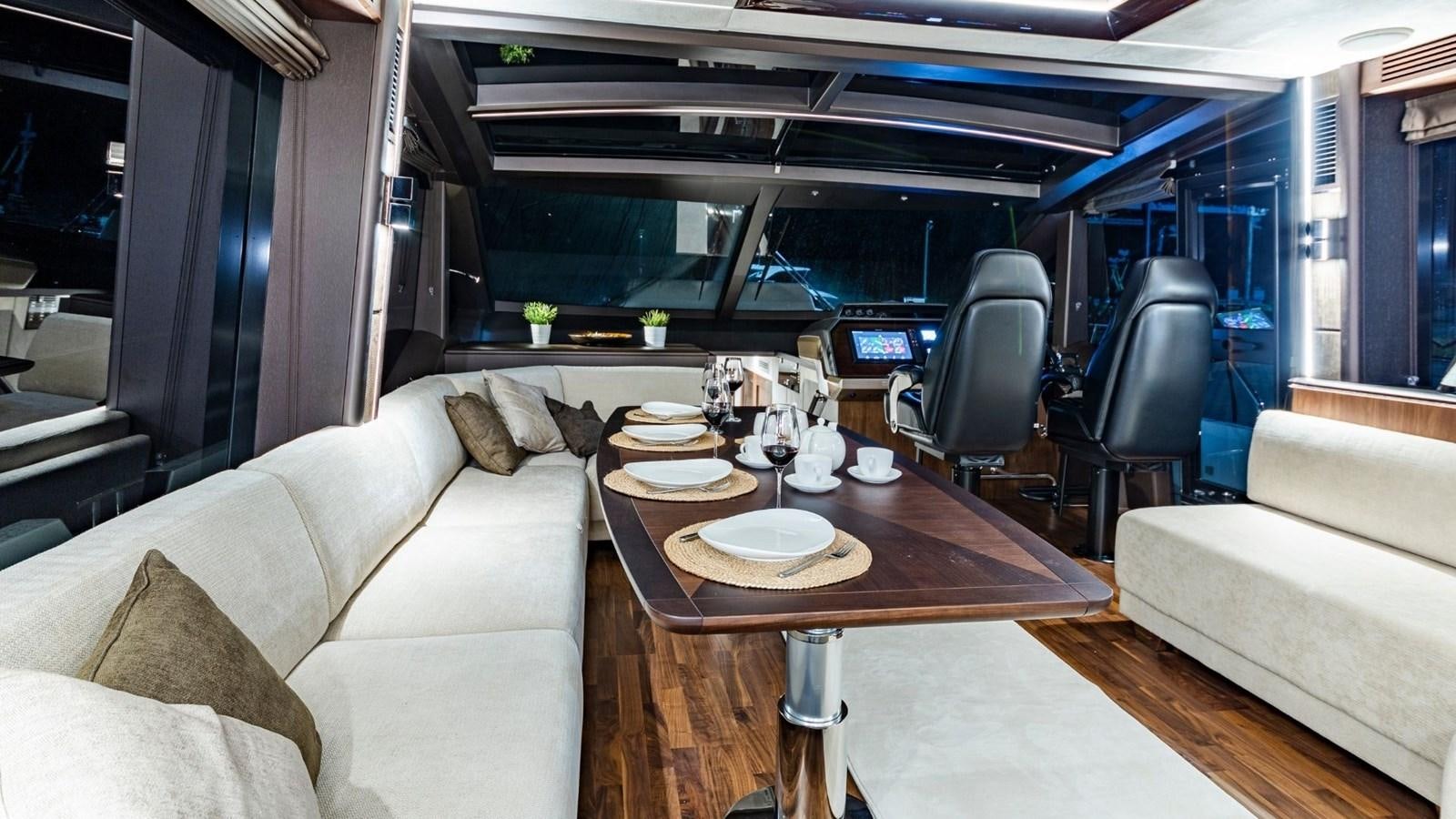 a living room with a table and couches aboard GALEON 680 FLY Yacht for Sale