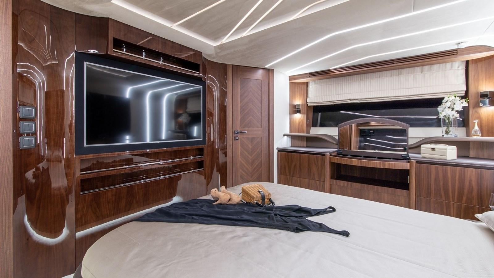 a bedroom with a bed and a microwave aboard GALEON 680 FLY Yacht for Sale