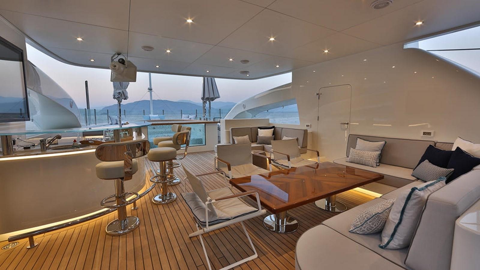 a room with a couch and a table and chairs aboard QUASAR Yacht for Charter