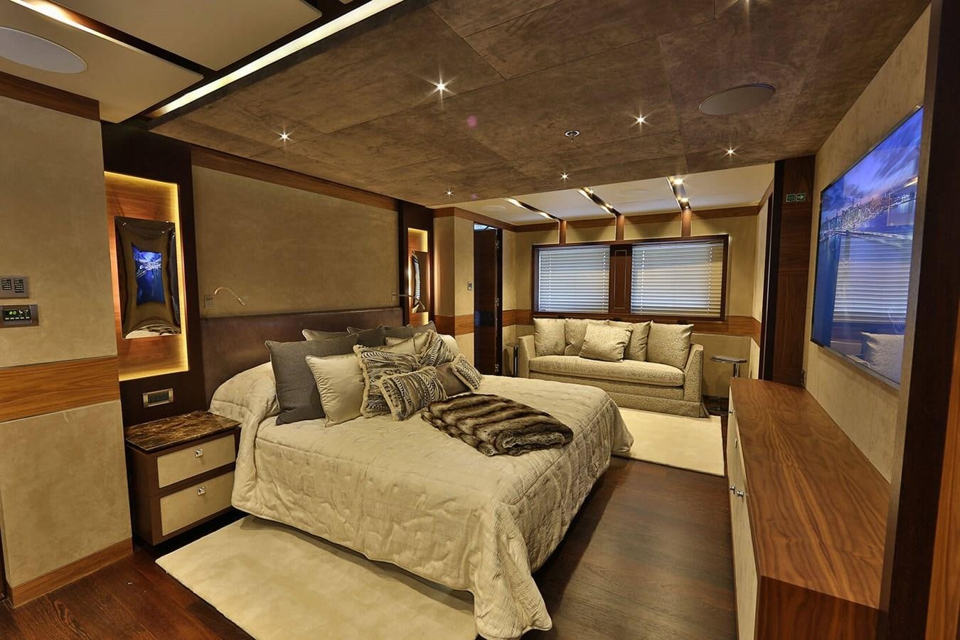 a bedroom with a bed and a couch aboard QUASAR Yacht for Charter