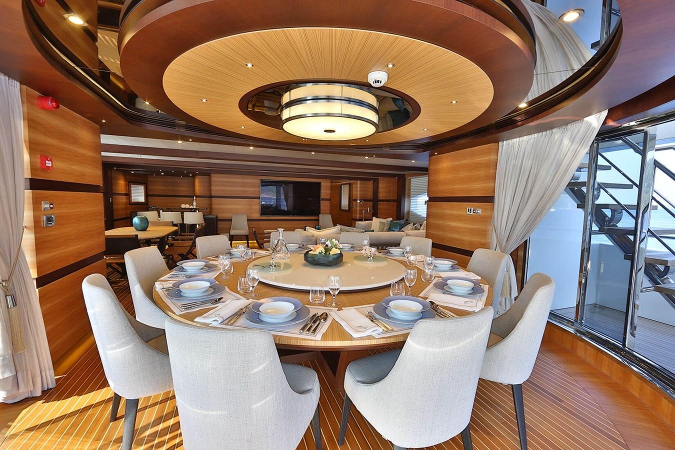 a dining room with a table set aboard QUASAR Yacht for Charter