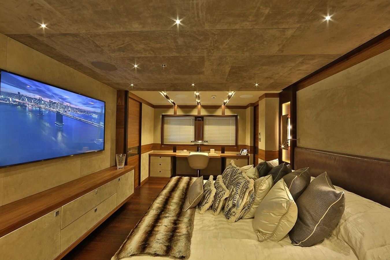 a large room with a tv and a couch aboard QUASAR Yacht for Charter