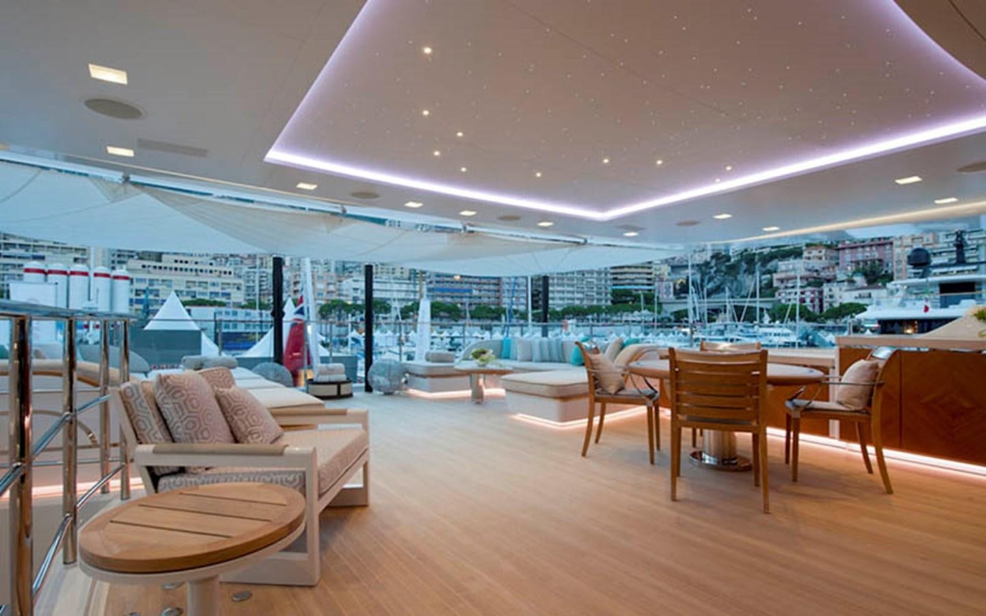 a room with a view of a city and a large pool aboard SCORPION Yacht for Sale