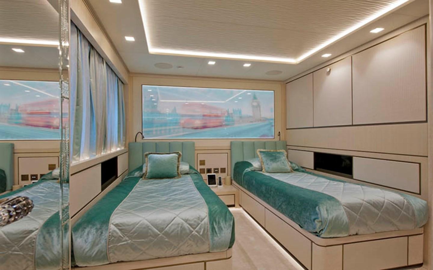 a room with beds and a large window aboard SCORPION Yacht for Sale