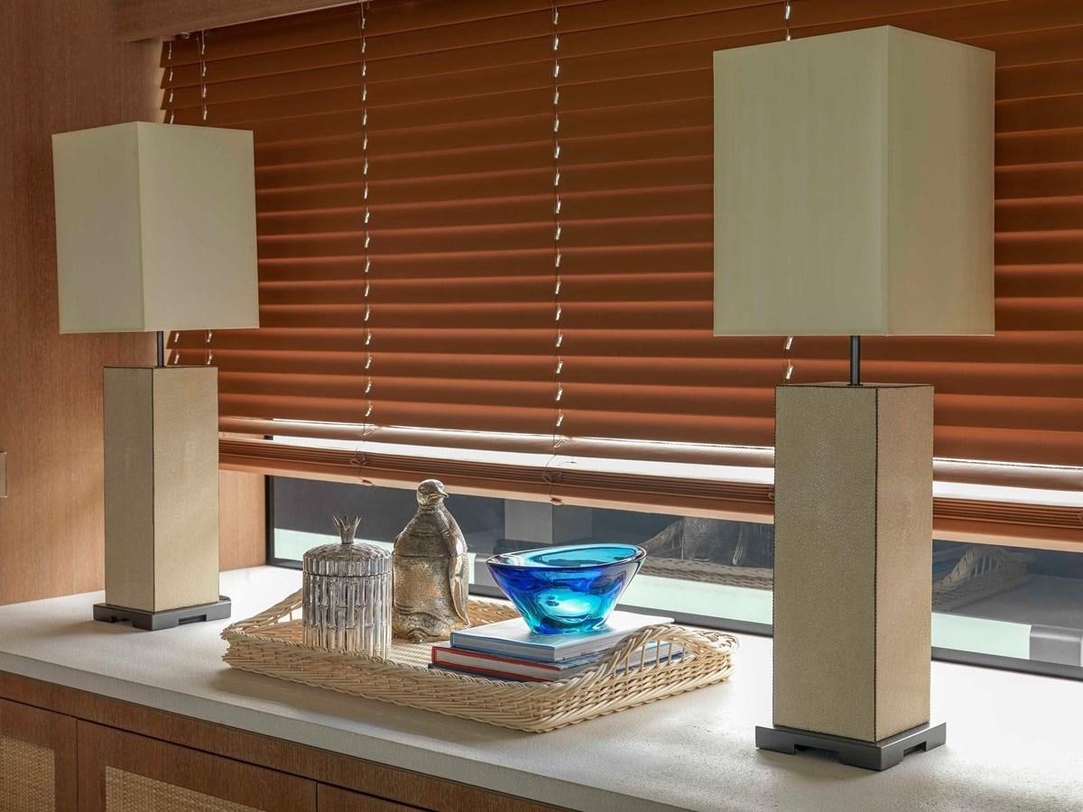 a white lamp next to a white lamp and a blue bowl on a table aboard PAIZA ONE Yacht for Sale