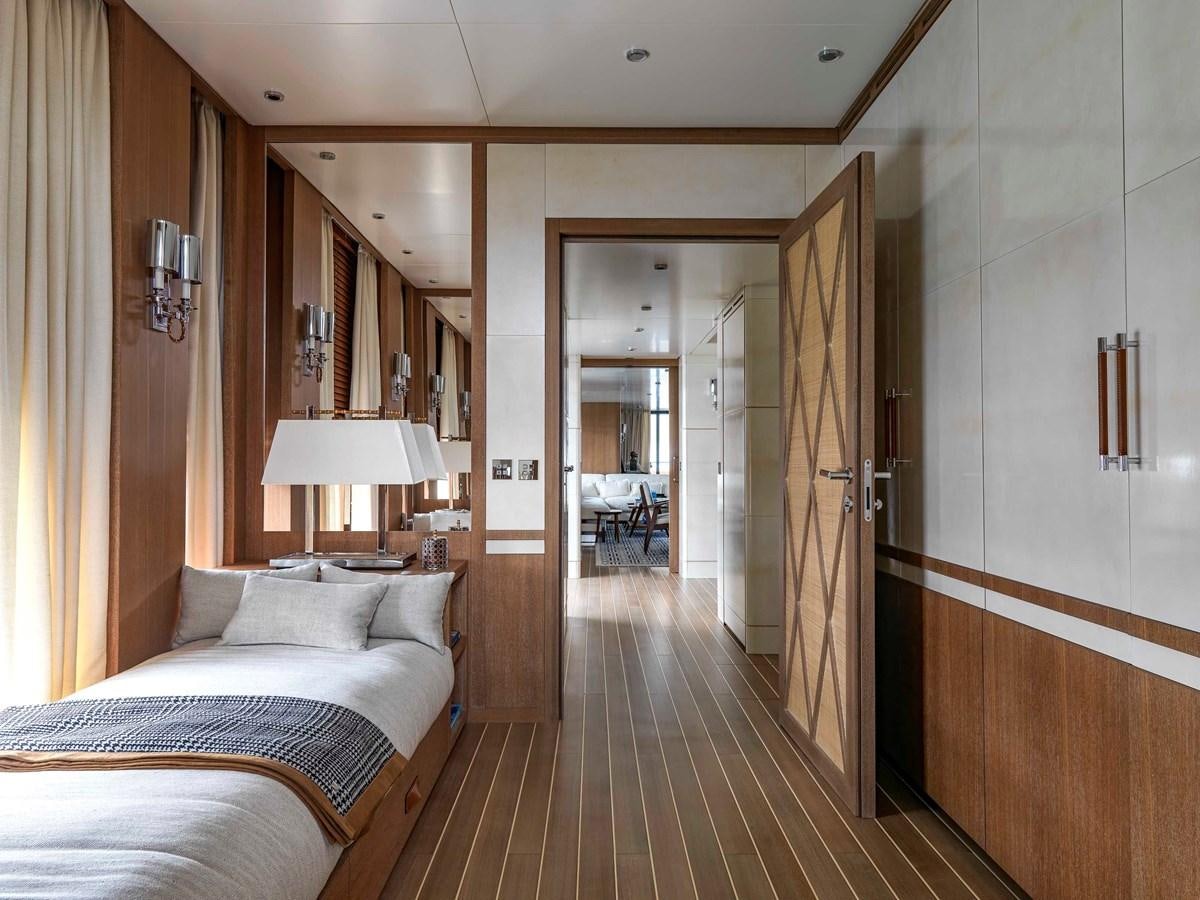 a hotel room with a bed and a mirror aboard PAIZA ONE Yacht for Sale