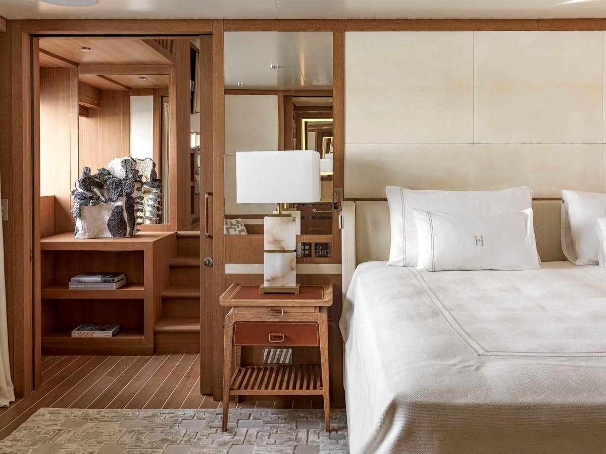 a bedroom with a bed and a mirror aboard PAIZA ONE Yacht for Sale