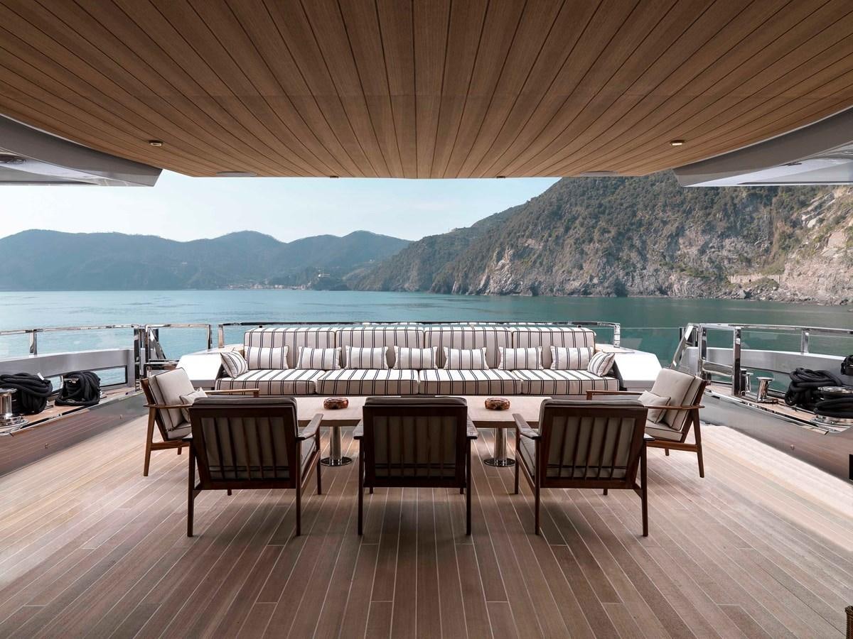 a patio with chairs and tables aboard PAIZA ONE Yacht for Sale