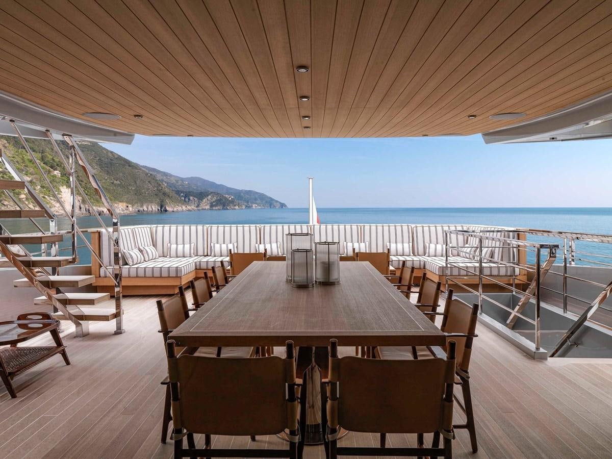 a table on a deck overlooking the ocean aboard PAIZA ONE Yacht for Sale