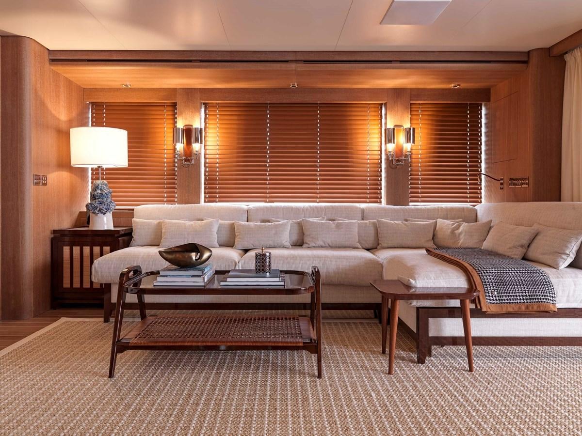 a living room with a couch and coffee table aboard PAIZA ONE Yacht for Sale