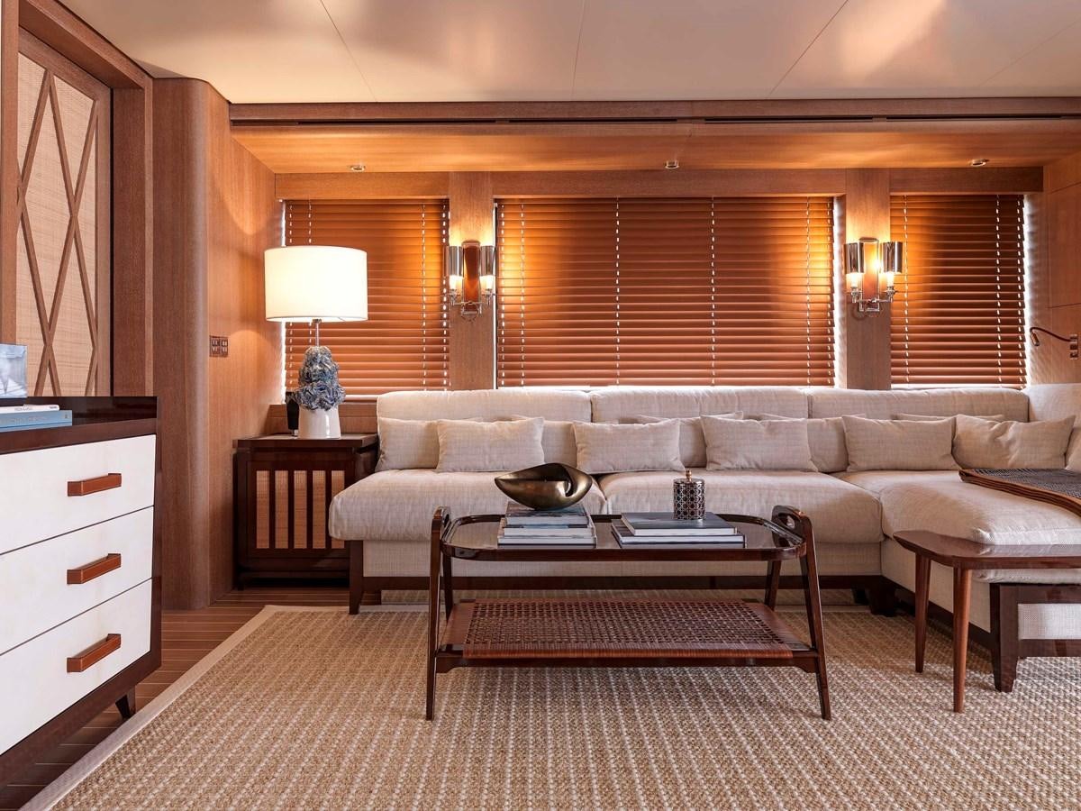 a living room with a couch and a coffee table aboard PAIZA ONE Yacht for Sale
