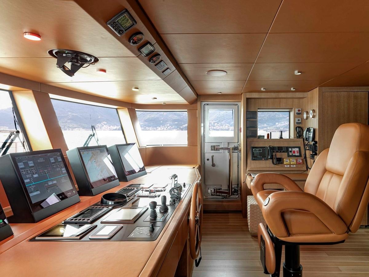a room with computers and chairs aboard PAIZA ONE Yacht for Sale