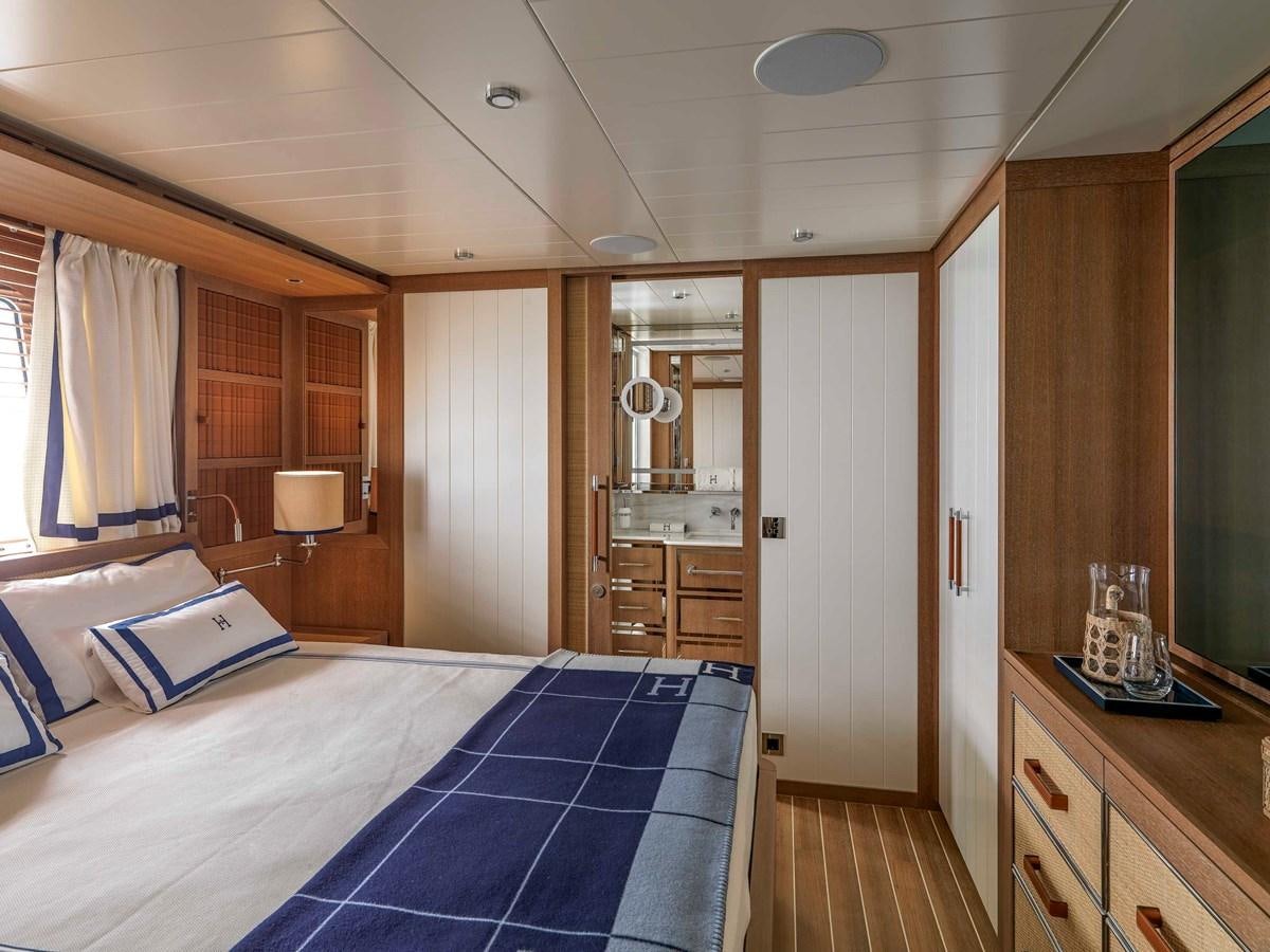 a bedroom with a bed and a desk aboard PAIZA ONE Yacht for Sale