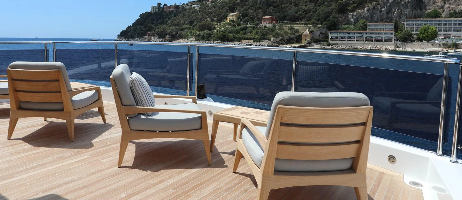 a deck with chairs and a body of water aboard ALADDIN Yacht for Sale
