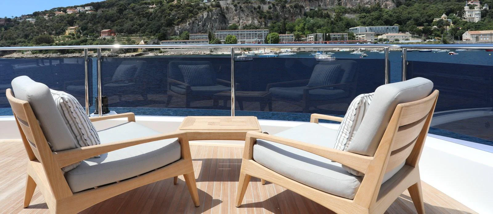 a group of chairs on a deck overlooking a body of water aboard ALADDIN Yacht for Sale