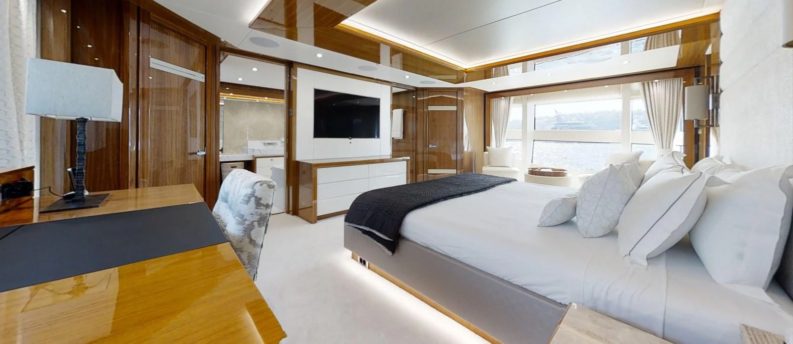 a bedroom with a bed and a tv aboard ALADDIN Yacht for Sale