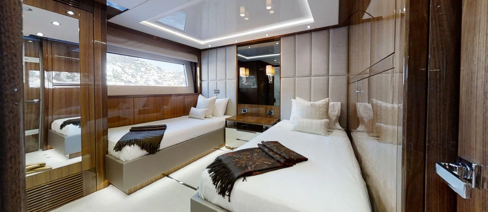 a room with a bed and a mirror aboard ALADDIN Yacht for Sale