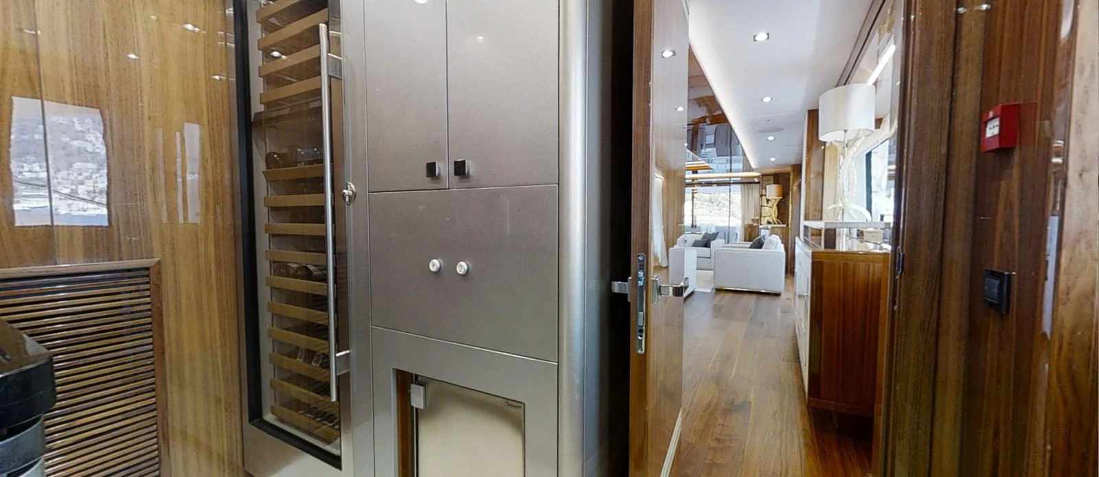 a room with a wood door and a wood cabinet with a white couch aboard ALADDIN Yacht for Sale