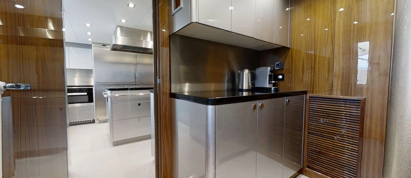 a kitchen with wooden cabinets aboard ALADDIN Yacht for Sale