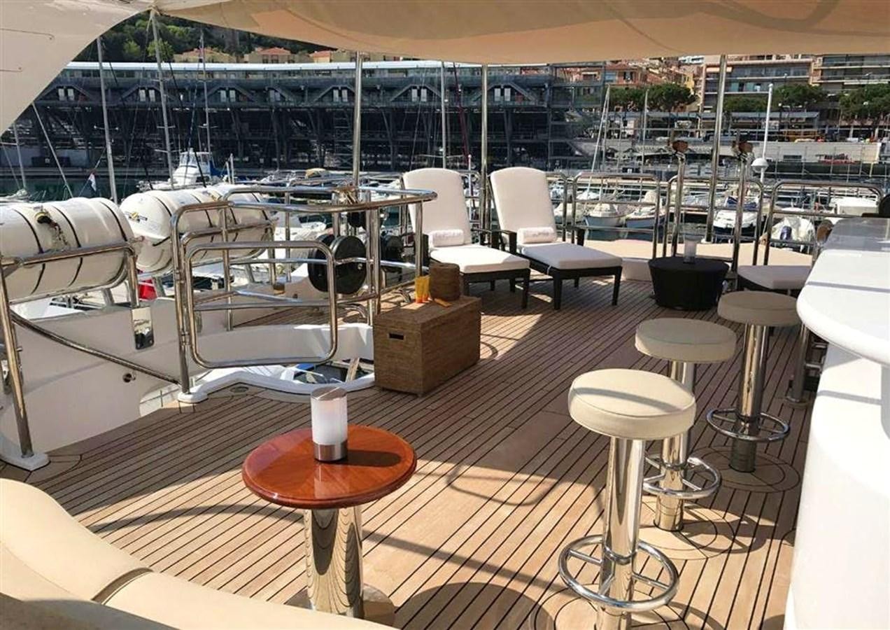 a room with tables and chairs aboard VIRTUE Yacht for Sale
