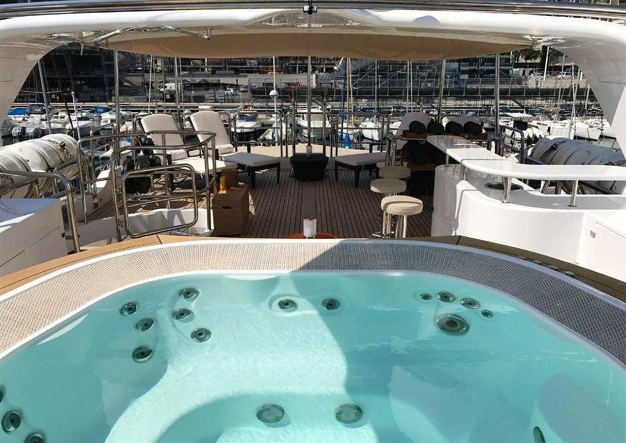 a pool with a table and chairs aboard VIRTUE Yacht for Sale