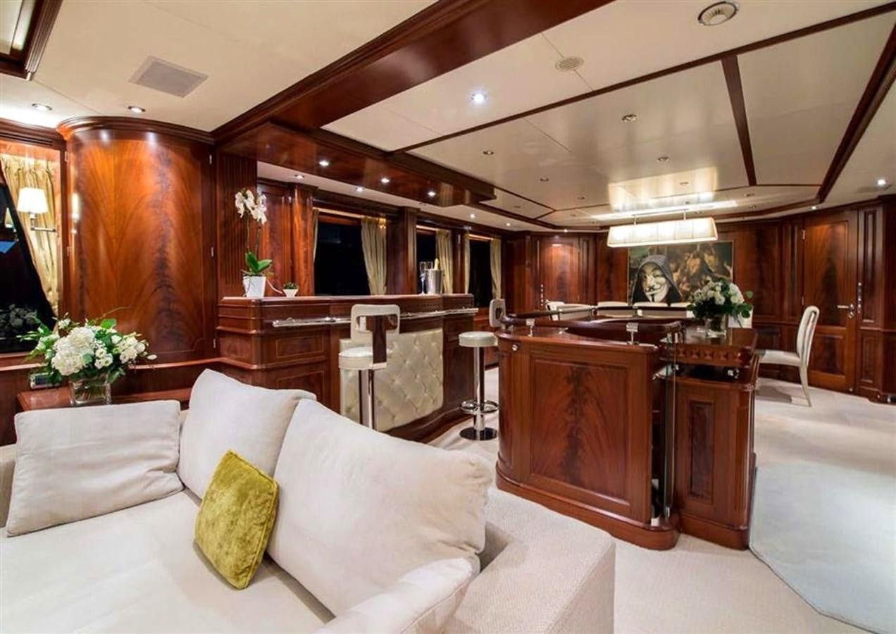 a large living room with a white couch and a piano aboard VIRTUE Yacht for Sale