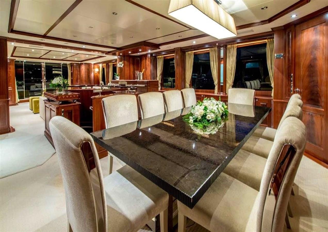 a large room with a table and chairs aboard VIRTUE Yacht for Sale