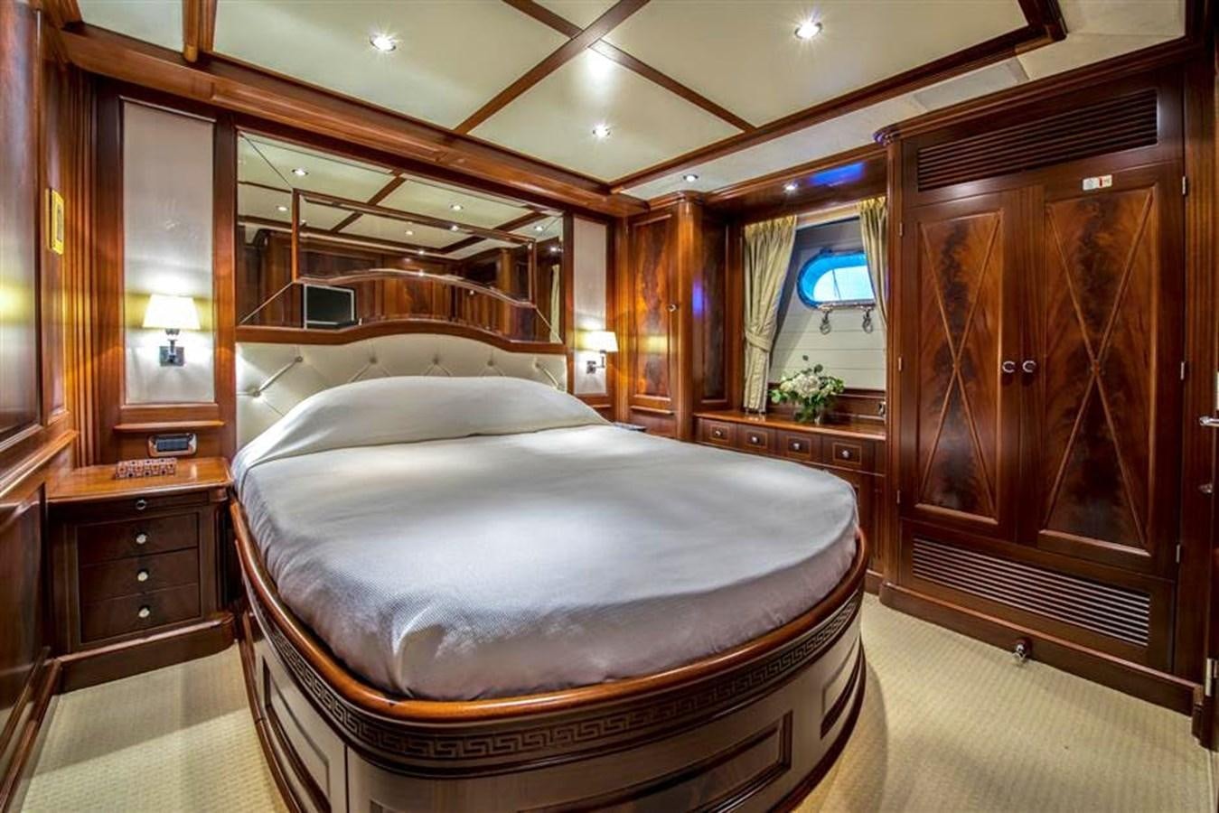 a bedroom with a bed and cabinets aboard VIRTUE Yacht for Sale