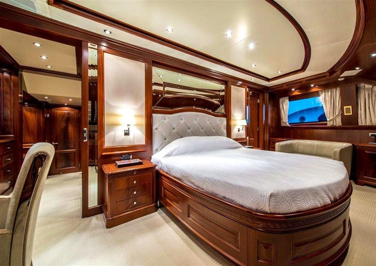 a bedroom with a bed and a tv aboard VIRTUE Yacht for Sale
