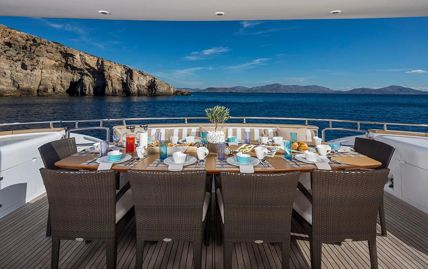 a table set for a meal on a beach aboard MAIORA 35 DP Yacht for Sale