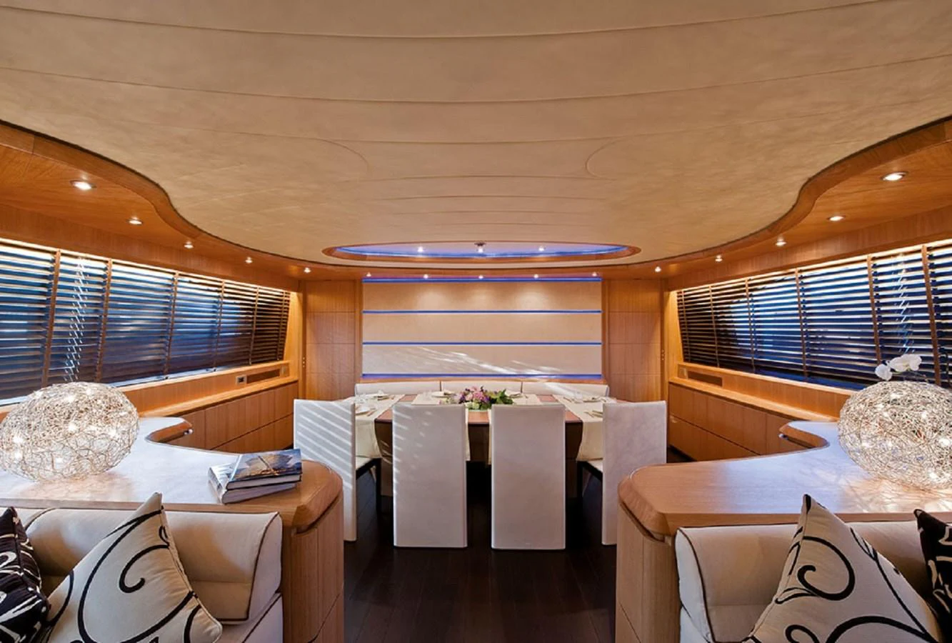 a room with a table and chairs aboard MAIORA 35 DP Yacht for Sale