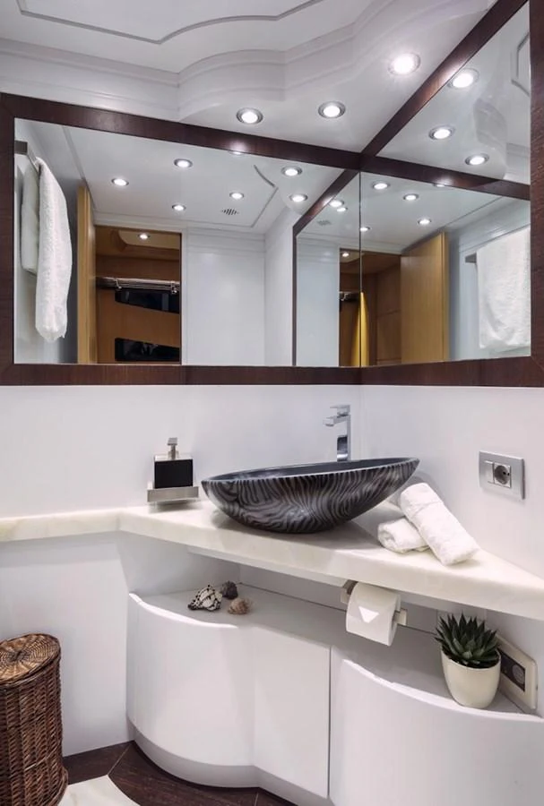 a bathroom with a sink and a mirror aboard MAIORA 35 DP Yacht for Sale
