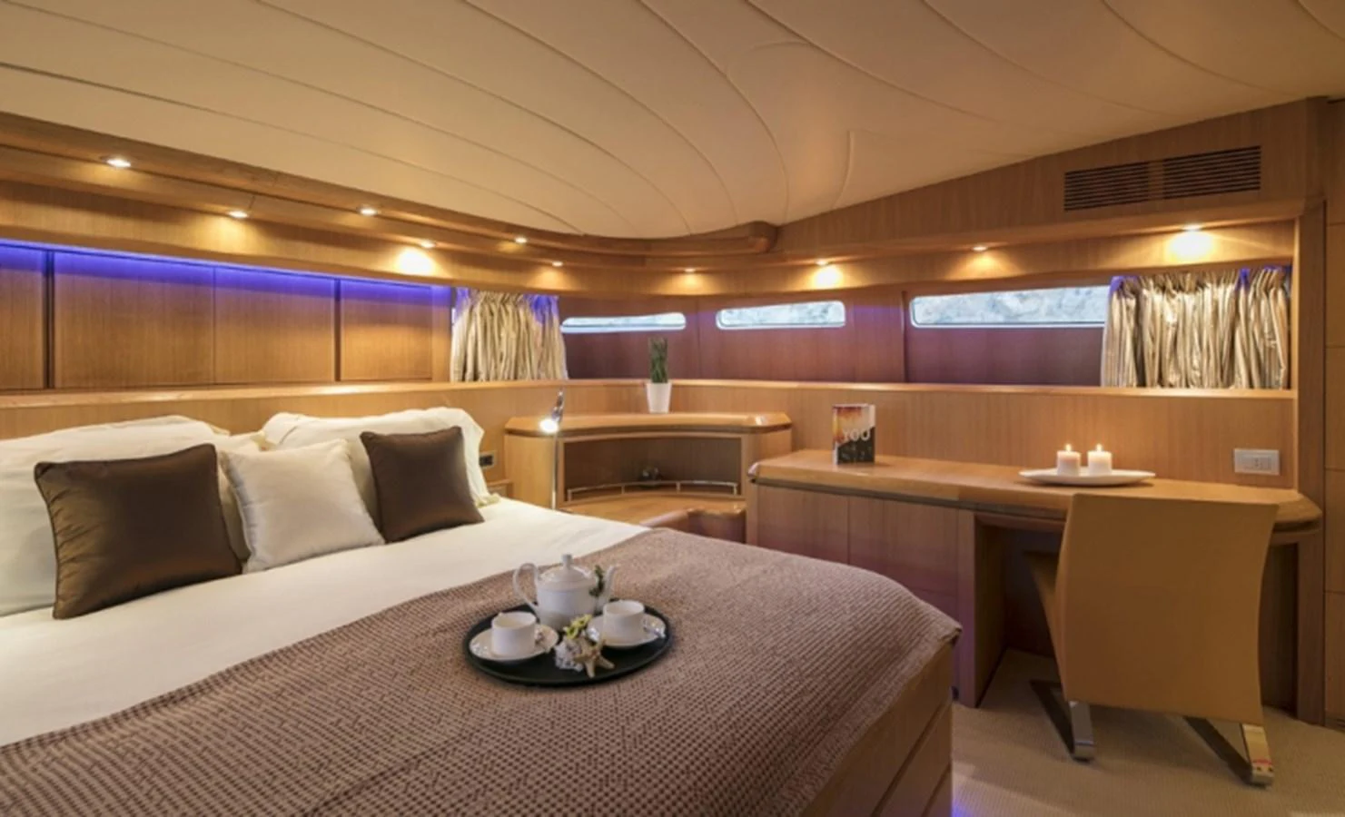 a room with a bed and a table aboard MAIORA 35 DP Yacht for Sale