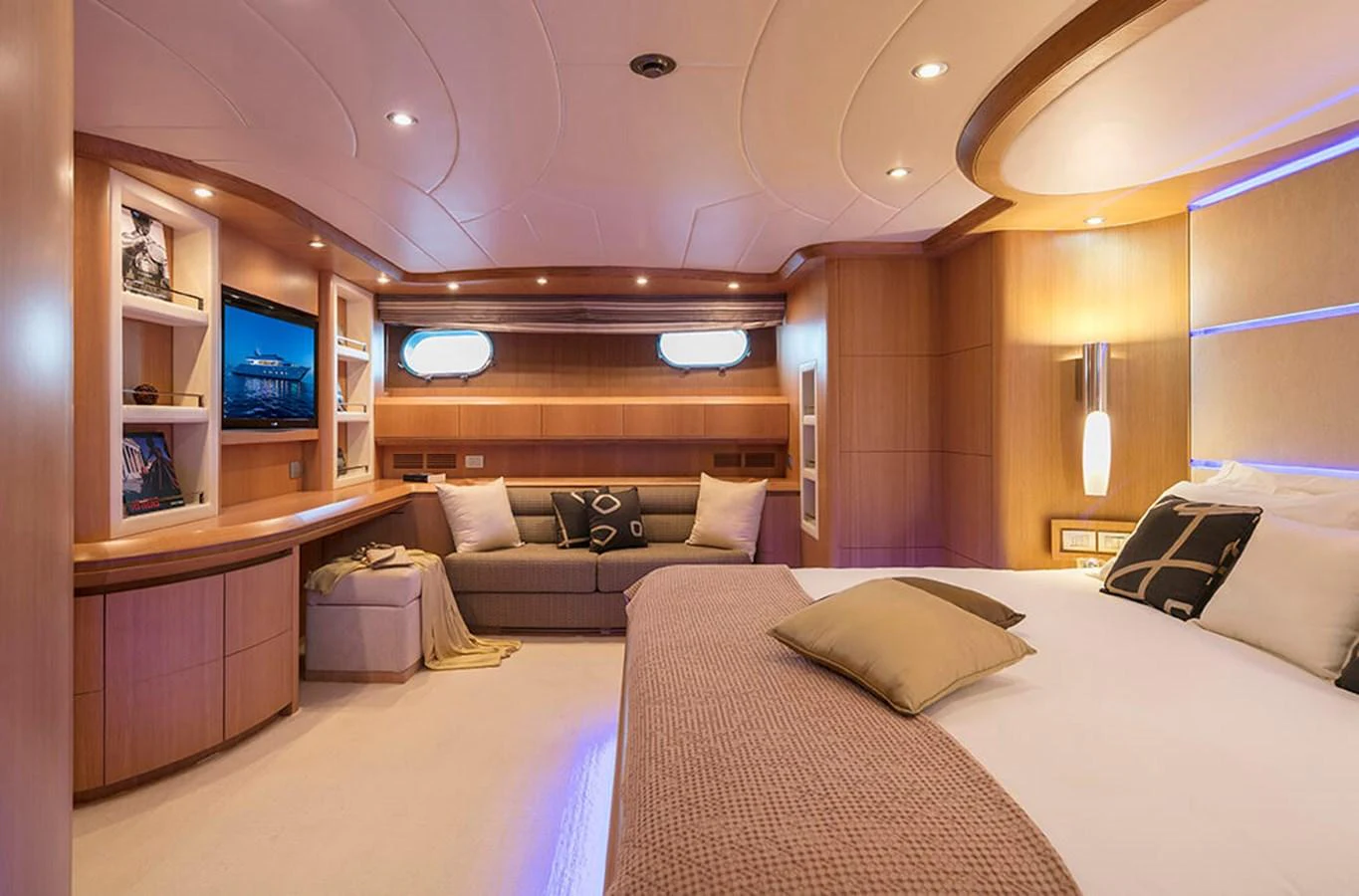 a room with a bed and a couch aboard MAIORA 35 DP Yacht for Sale