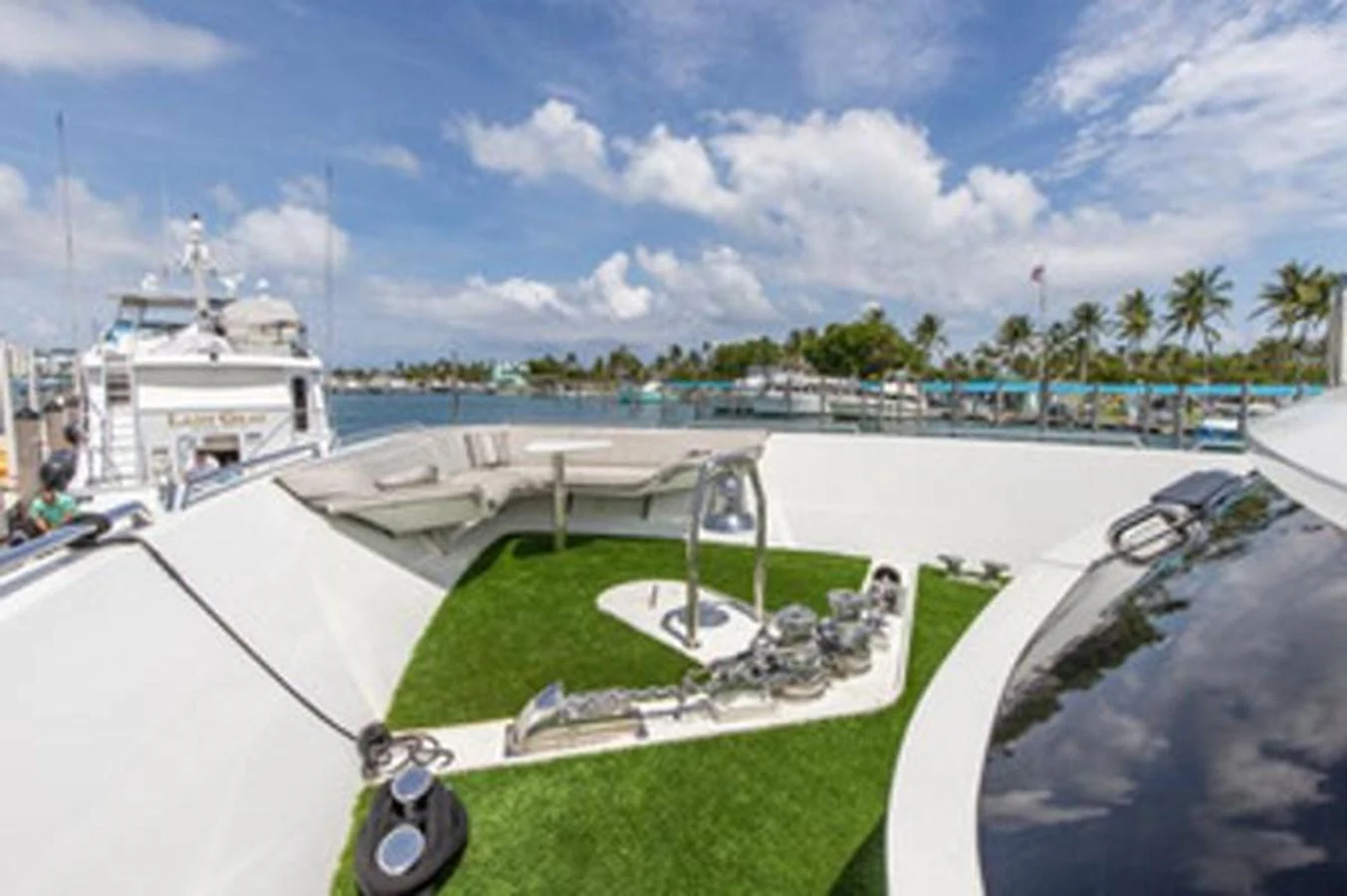 a golf course with a large ship in the background aboard 2000 116 BAGLIETTO Yacht for Sale