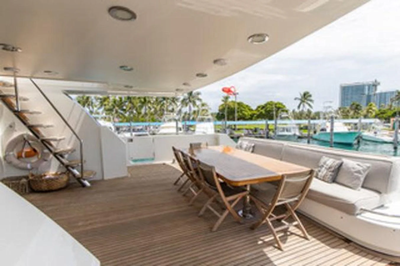 a room with a table chairs and a pool aboard 2000 116 BAGLIETTO Yacht for Sale