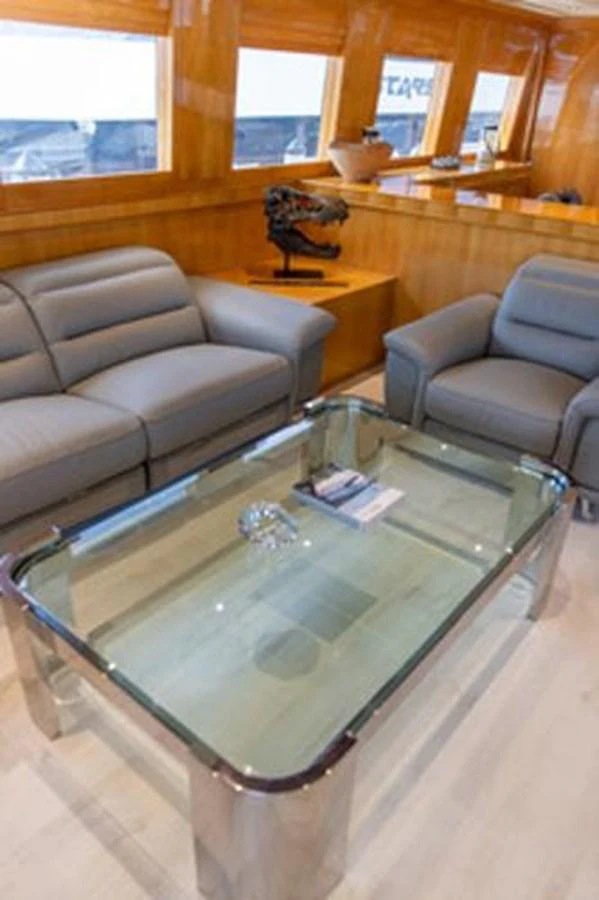 a living room with a couch and a coffee table aboard 2000 116 BAGLIETTO Yacht for Sale