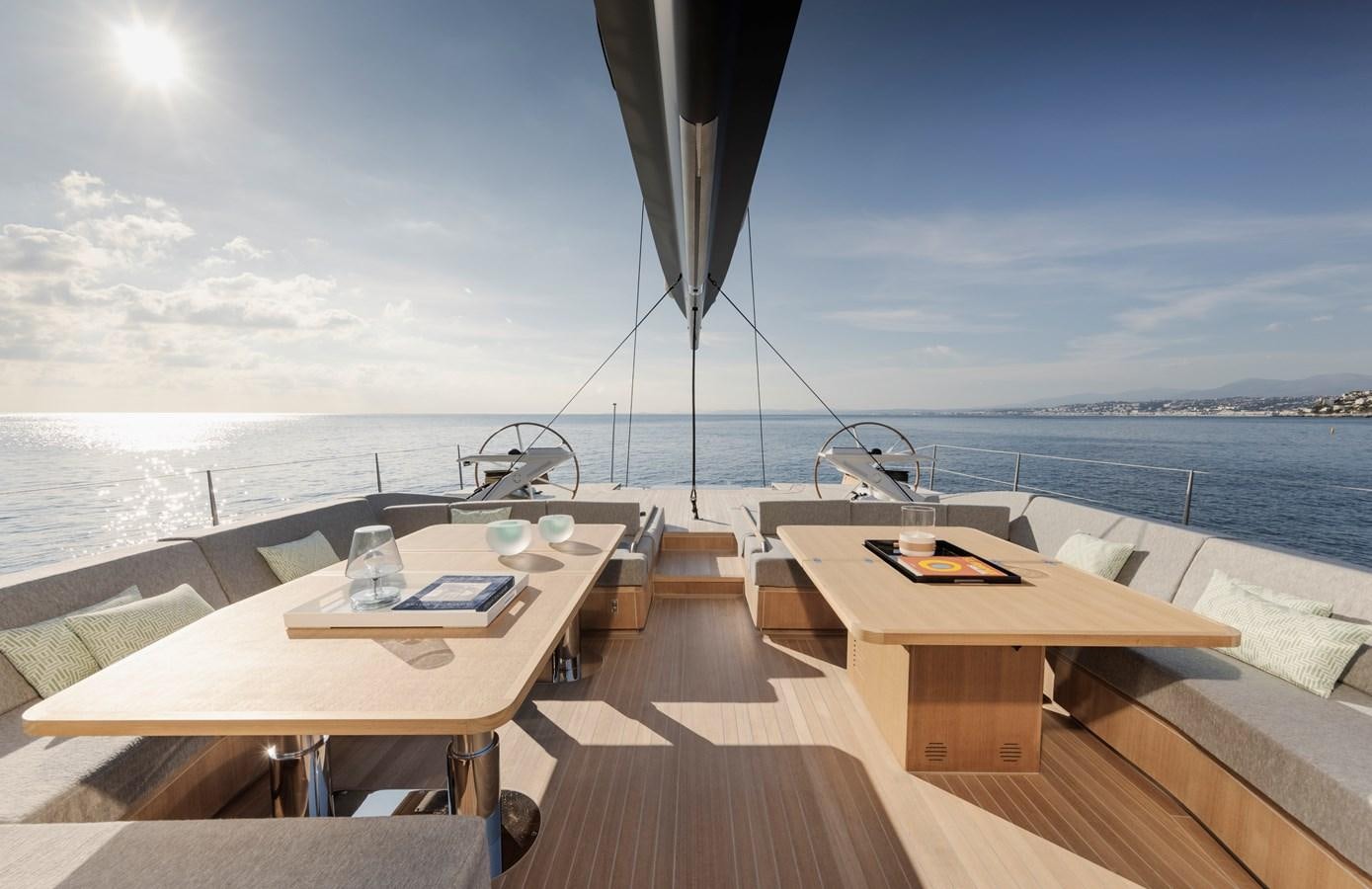 a table and chairs on a deck overlooking a body of water aboard CEFEA Yacht for Charter