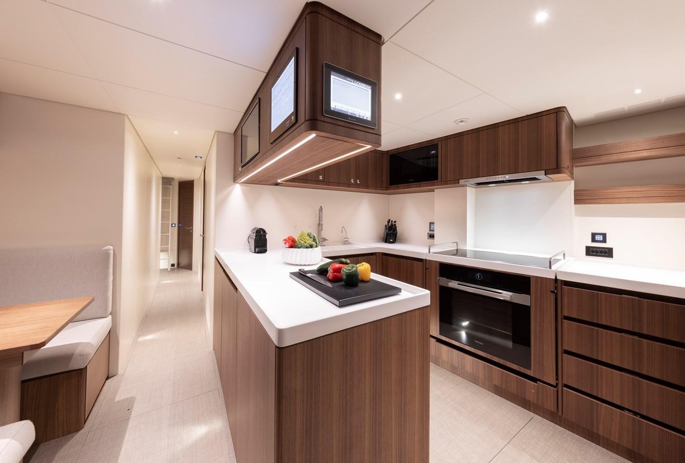 a kitchen with a large island aboard CEFEA Yacht for Charter