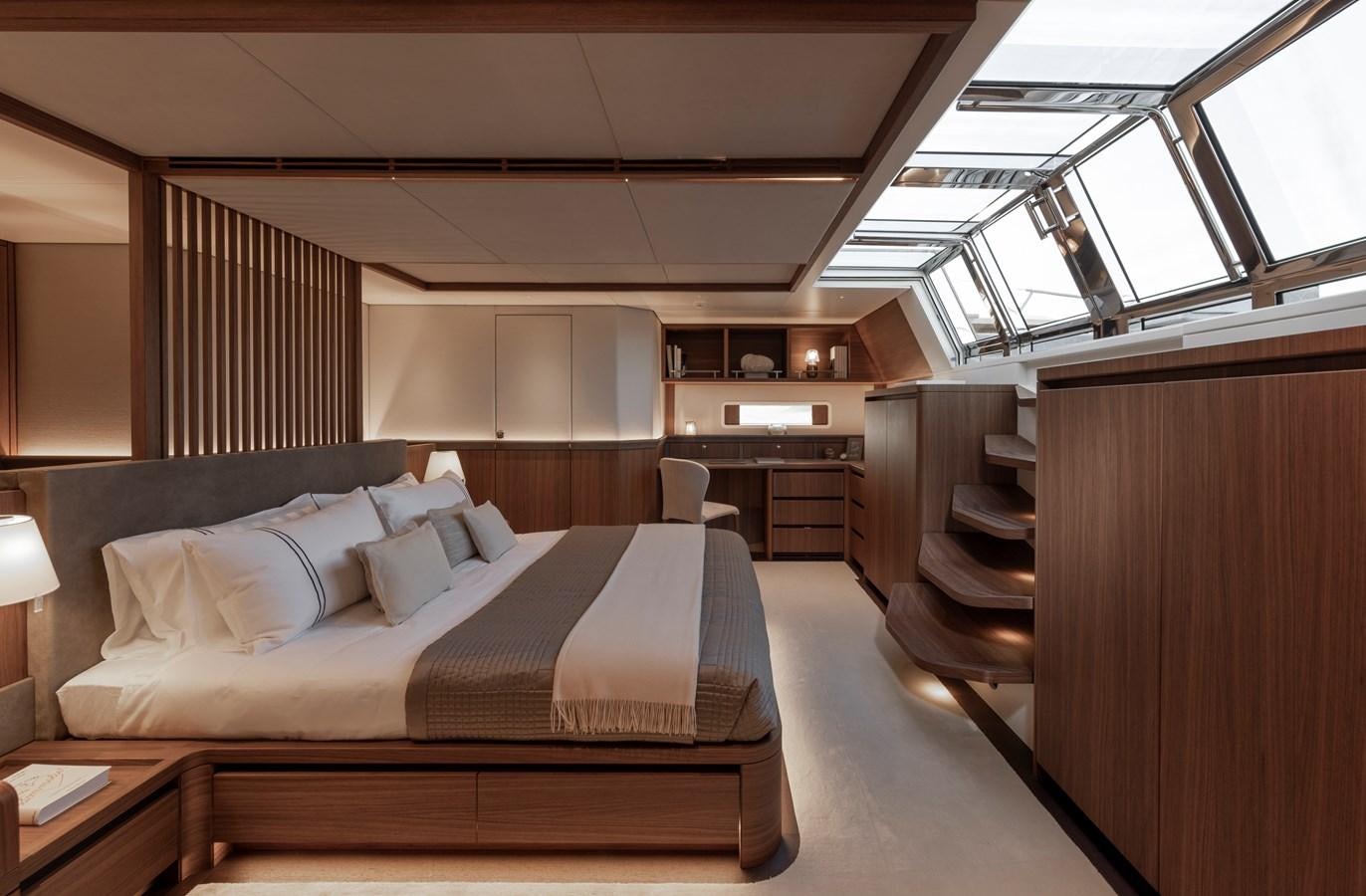 a room with a bed and a chair aboard CEFEA Yacht for Charter