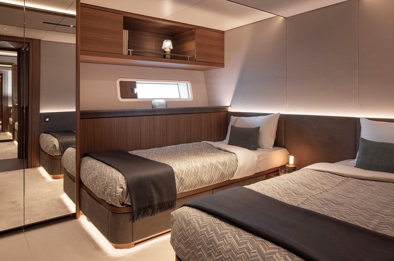 a hotel room with two beds aboard CEFEA Yacht for Charter