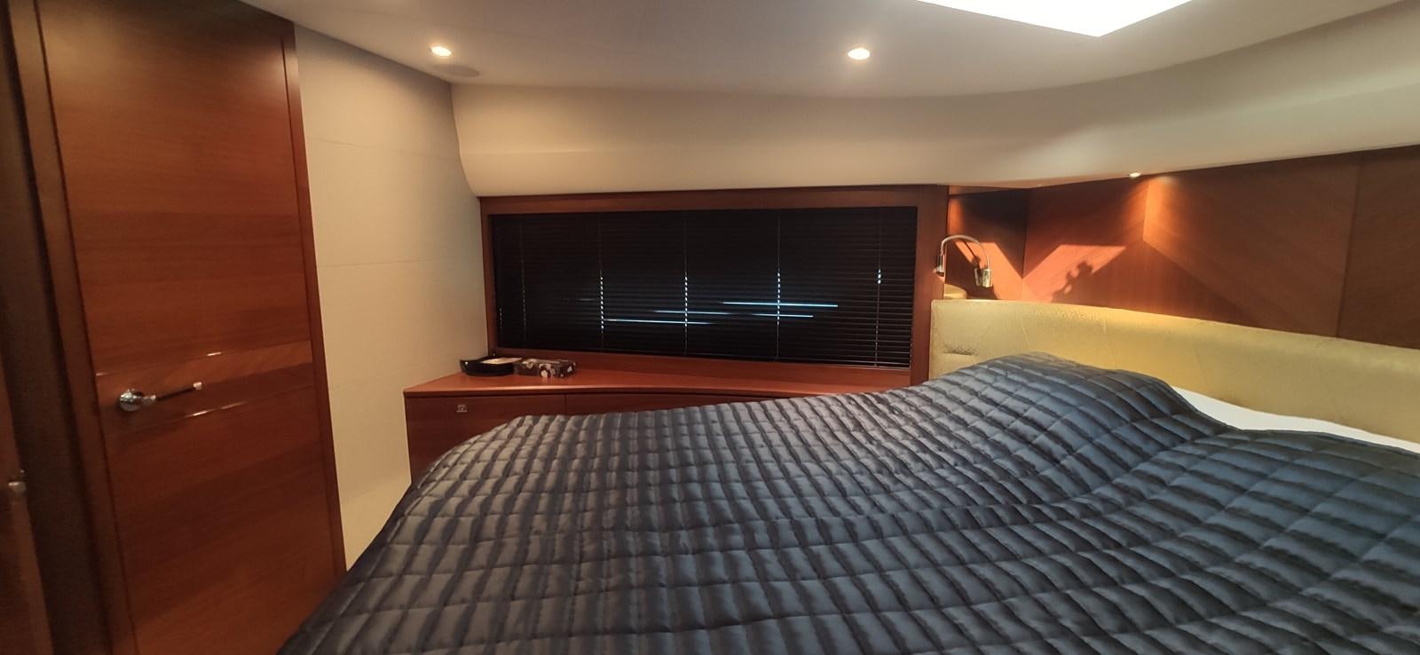 a bedroom with a bed and a dresser aboard ANOTHER TOY Yacht for Sale