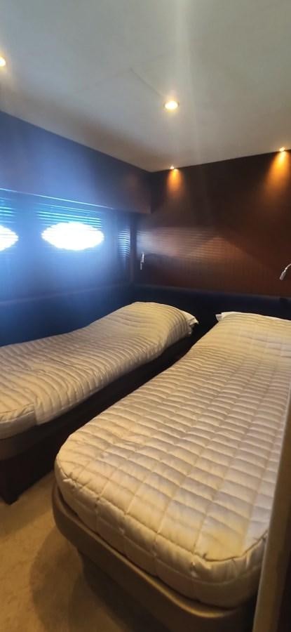 a bed with a blue wall aboard ANOTHER TOY Yacht for Sale