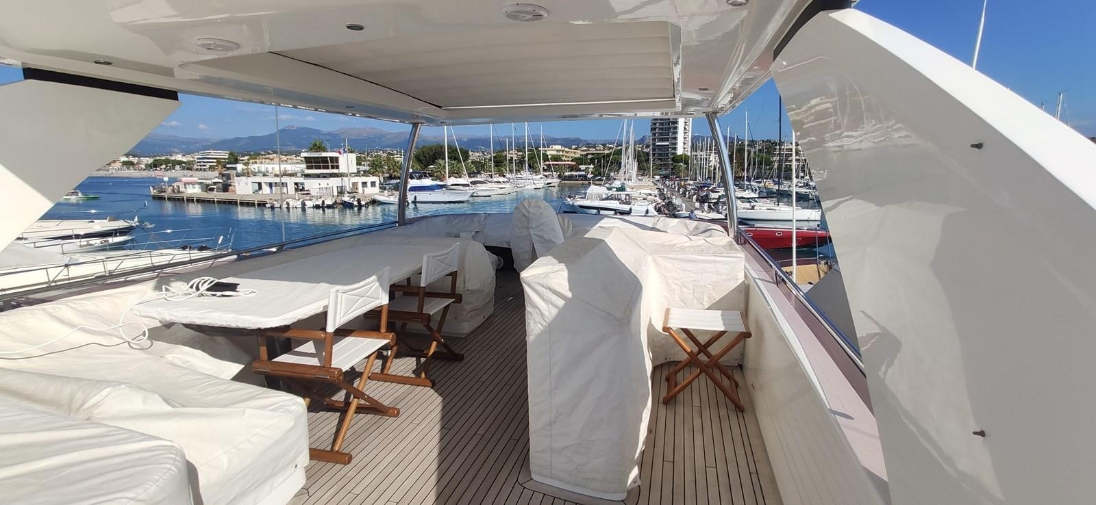 a deck with chairs and tables on it aboard ANOTHER TOY Yacht for Sale